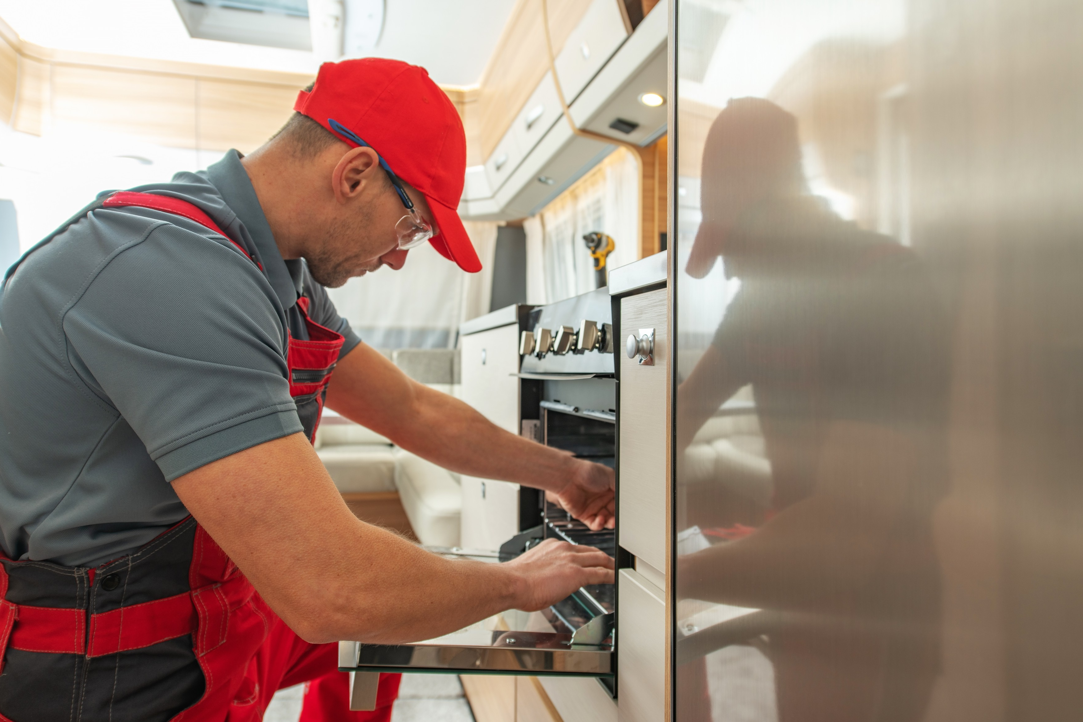 Appliance technician repairing an oven