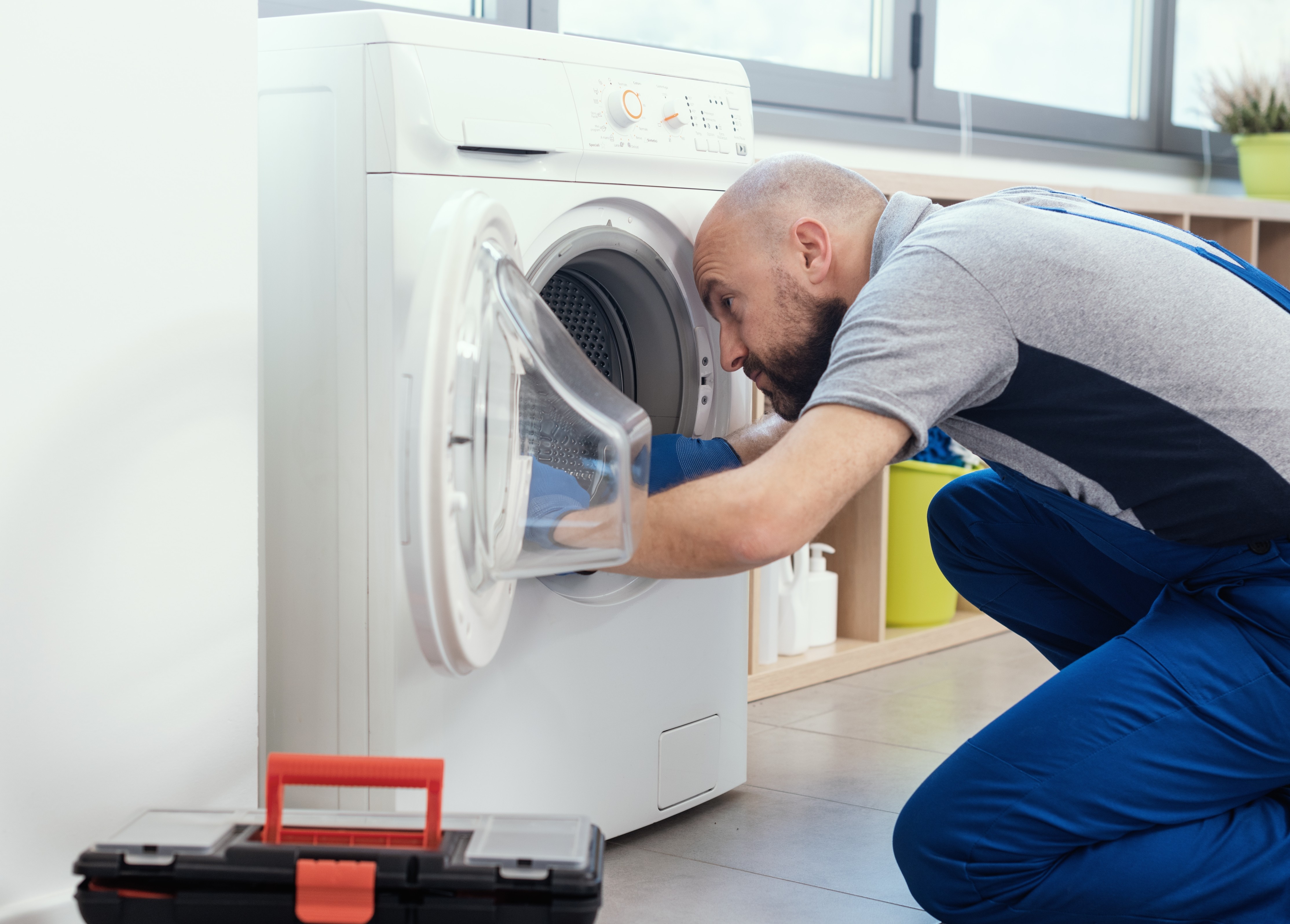 Technician repairing a washing machine