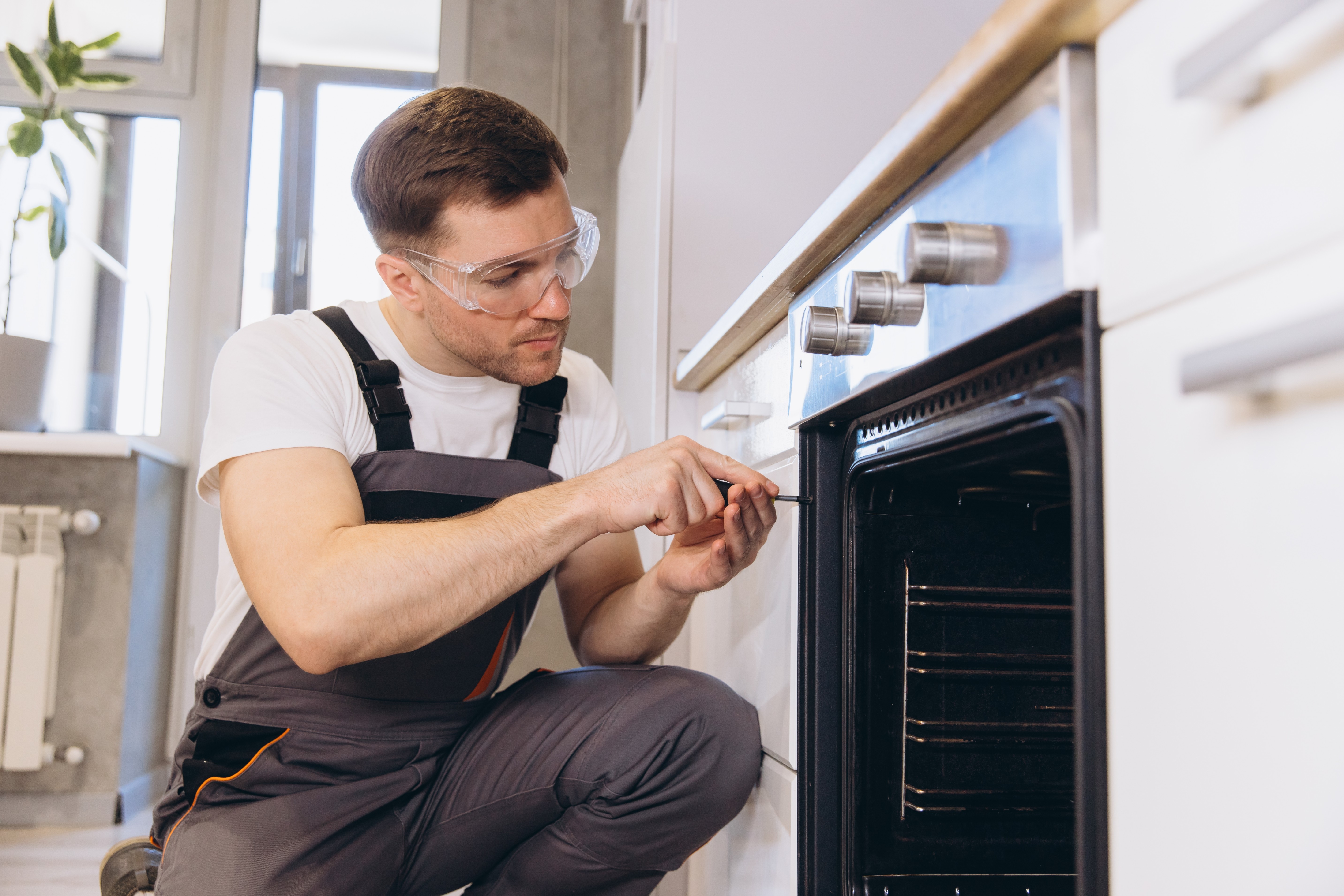 Technician repairing an oven